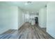 Open-concept living space with wood-look flooring flowing into the adjacent kitchen at 160 Fisher Loop, Ocklawaha, FL 32179
