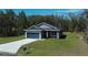 Charming single-story home featuring a modern facade, attached garage, and freshly laid concrete driveway at 160 Fisher Way Trl, Ocklawaha, FL 32179