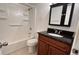 Bathroom featuring tub with shower, decorative vanity and tiled flooring at 1651 W Oak Ridge Rd # 1651A, Orlando, FL 32809