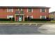 Exterior view of condo featuring a welcoming entrance, well-maintained lawn, and convenient parking at 1651 W Oak Ridge Rd # 1651A, Orlando, FL 32809