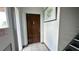 Hallway view with staircase, tile floors, apartment door and a framed picture at 1651 W Oak Ridge Rd # 1651A, Orlando, FL 32809