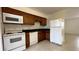 Efficient kitchen featuring ample counter space, white appliances, and tile flooring at 1651 W Oak Ridge Rd # 1651A, Orlando, FL 32809