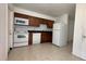 Efficient kitchen featuring ample counter space, white appliances, and tile flooring at 1651 W Oak Ridge Rd # 1651A, Orlando, FL 32809