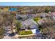 Aerial view of a charming single-Gathering home with lush landscaping and a serene lake nearby at 1701 Knotting Hill Dr, Orlando, FL 32835