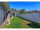 Well-maintained backyard with a white fence and screened-in porch, perfect for outdoor enjoyment and privacy at 1701 Knotting Hill Dr, Orlando, FL 32835