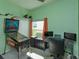 Bedroom features a pinball machine, game station, and a window overlooking the yard at 1701 Knotting Hill Dr, Orlando, FL 32835