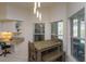 Bright dining area with a desk features stylish pendant lighting and comfortable seating at 1701 Knotting Hill Dr, Orlando, FL 32835