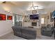 Cozy living room with fireplace, built-in shelving, and sliding doors to the lanai at 1701 Knotting Hill Dr, Orlando, FL 32835
