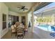 Relaxing covered patio with outdoor dining set near the inviting pool at 1701 Knotting Hill Dr, Orlando, FL 32835