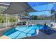 Sun-drenched pool is surrounded by comfortable lounge furniture, creating a perfect space for outdoor entertaining at 1701 Knotting Hill Dr, Orlando, FL 32835