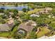 Aerial view of a home with a screened in pool overlooking a lake and golf course at 1723 Lee Janzen Dr, Kissimmee, FL 34744