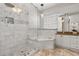 Luxurious bathroom featuring a walk-in shower, soaking tub, and double vanity with granite countertop at 1723 Lee Janzen Dr, Kissimmee, FL 34744