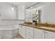 Bright bathroom features double sinks, a granite countertop, a soaking tub and a walk-in shower at 1723 Lee Janzen Dr, Kissimmee, FL 34744