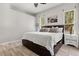 Bedroom with two windows, light gray walls, and wood-look tile floors at 1723 Lee Janzen Dr, Kissimmee, FL 34744