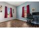 Spacious bedroom with hardwood floors, two large windows, and ample natural light at 1723 Lee Janzen Dr, Kissimmee, FL 34744