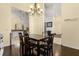Dining room with a dark wood table set and views to the kitchen at 1723 Lee Janzen Dr, Kissimmee, FL 34744