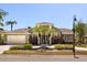 Beautiful home featuring lush landscaping, palm trees, and a well-maintained lawn at 1723 Lee Janzen Dr, Kissimmee, FL 34744