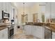 Bright kitchen with white cabinets, granite countertops, and stainless steel appliances at 1723 Lee Janzen Dr, Kissimmee, FL 34744