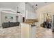 Open kitchen with granite countertops, white cabinets, and seamless flow into the living and dining areas at 1723 Lee Janzen Dr, Kissimmee, FL 34744