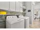 Laundry room with white cabinets, sink, washer, and dryer at 1723 Lee Janzen Dr, Kissimmee, FL 34744