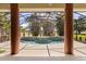 Screened in pool area features a stone water feature and tropical landscaping at 1723 Lee Janzen Dr, Kissimmee, FL 34744
