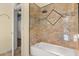 Bathroom featuring a shower with decorative tile surround and a white tub at 1723 Lee Janzen Dr, Kissimmee, FL 34744