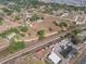 Birds eye view showcasing the property's layout near railroad tracks and the residential neighborhood nearby at 2300 Olsen Rd, Haines City, FL 33844