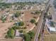 High-angle showcasing the property with surrounding roads, railroad tracks, and neighborhood homes at 2300 Olsen Rd, Haines City, FL 33844
