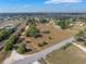 Elevated view showing the property's dimensions alongside roads, railroad tracks, and nearby residences at 2300 Olsen Rd, Haines City, FL 33844