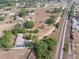 Aerial view showcasing the property adjacent to a lush landscape and railroad track at 2300 Olsen Rd, Haines City, FL 33844