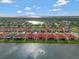 Stunning aerial view of a lakeside community with well-maintained homes and red tile roofs at 2335 Symphony Cir, St Cloud, FL 34771