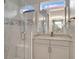 Bright bathroom featuring a glass-enclosed shower with marble tiles and a vanity with granite countertop at 2335 Symphony Cir, St Cloud, FL 34771