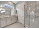 Contemporary bathroom showcasing a walk-in shower with a seat and accessible features, plus a granite-topped vanity at 2335 Symphony Cir, St Cloud, FL 34771