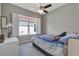 Bedroom with neutral walls, plush carpet, modern ceiling fan, and window with plantation shutters at 2335 Symphony Cir, St Cloud, FL 34771