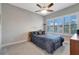 Cozy bedroom with neutral walls, ceiling fan, carpet flooring, and window with plantation shutters at 2335 Symphony Cir, St Cloud, FL 34771