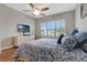 Bedroom with hardwood floors, a ceiling fan, and a large window with plantation shutters at 2335 Symphony Cir, St Cloud, FL 34771