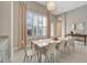Charming dining room with modern table, seating for ten, and natural light from plantation shutters at 2335 Symphony Cir, St Cloud, FL 34771