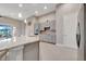 Gorgeous kitchen features a marble countertop, stainless steel appliances, tile backsplash, and gray cabinets at 2335 Symphony Cir, St Cloud, FL 34771
