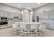 Modern kitchen boasts a large island with seating, stainless steel appliances, and stylish gray cabinets at 2335 Symphony Cir, St Cloud, FL 34771
