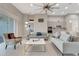 Bright open living room with tile flooring, modern furnishings, and seamless kitchen access at 2335 Symphony Cir, St Cloud, FL 34771