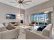 Spacious living room featuring neutral tones, modern decor, and sliding glass doors to the lanai at 2335 Symphony Cir, St Cloud, FL 34771