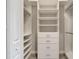 Well-lit walk-in closet with custom shelving, drawers, and hanging rods, maximizing organization and convenience at 2335 Symphony Cir, St Cloud, FL 34771