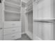 Organized walk-in closet with white shelving and drawers, offering ample storage space for clothes and accessories at 2335 Symphony Cir, St Cloud, FL 34771