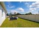 This large backyard features a firepit and outdoor furniture creating a welcoming space for relaxation and entertaining at 2547 Great Heron Ave, St Cloud, FL 34773