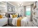 Modern bedroom with gray bed, stylish decor, and window with natural light at 2547 Great Heron Ave, St Cloud, FL 34773