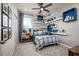 Cozy bedroom features a plaid bedspread, bright blue shelving, and natural light from the window at 2547 Great Heron Ave, St Cloud, FL 34773