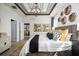 Bedroom with tray ceiling, decorative wall art, and luxurious bedding at 2547 Great Heron Ave, St Cloud, FL 34773