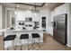 Open kitchen with stainless steel appliances, a center island with seating, and modern pendant lighting at 2547 Great Heron Ave, St Cloud, FL 34773