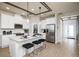 Bright, all-white kitchen features stainless appliances, tile backsplash, and wood-look flooring at 2547 Great Heron Ave, St Cloud, FL 34773