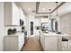 Bright, all-white kitchen features stainless appliances, tile backsplash, and wood-look flooring at 2547 Great Heron Ave, St Cloud, FL 34773